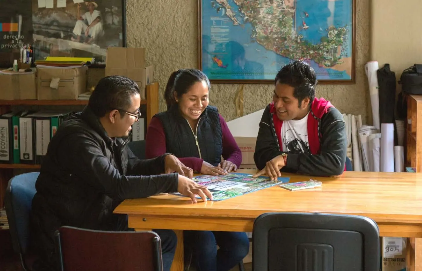Acceso partners collaborating around printed workshop materials