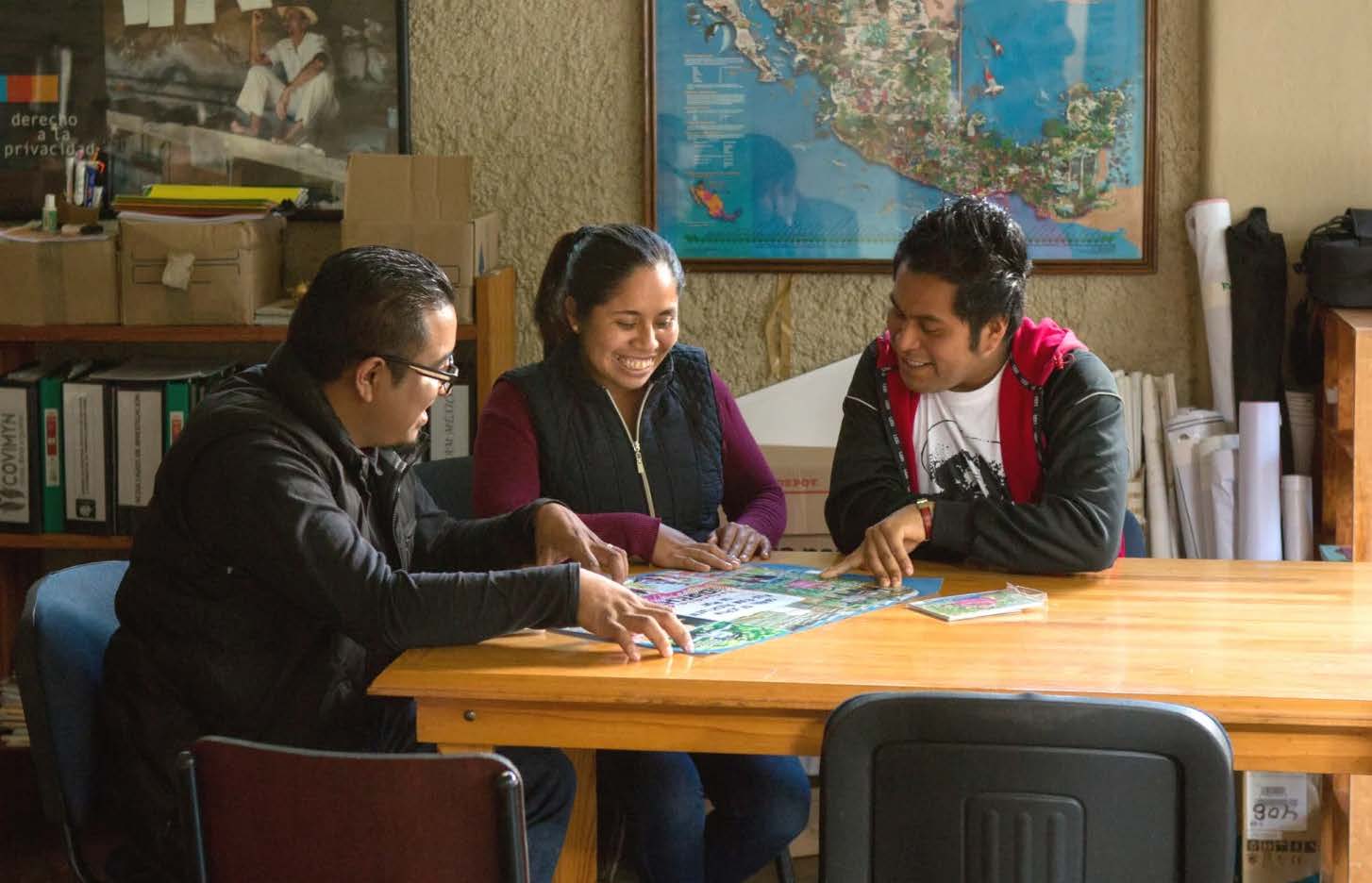Acceso partners collaborating around printed workshop materials